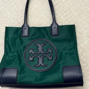 Tory Burch Emerald green navy blue handles and logo in front.